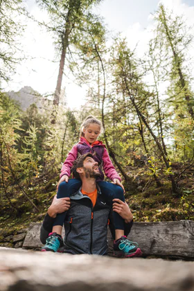 A family enjoys time hiking in the mountains.