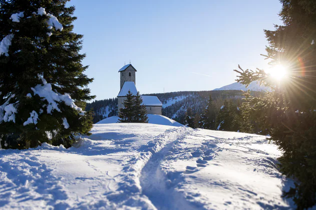 A snow-covered church in a snowy landscape