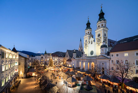 View of the Christmas market on the Brixen/Bressanone Cathedral Square and the cathedral itself