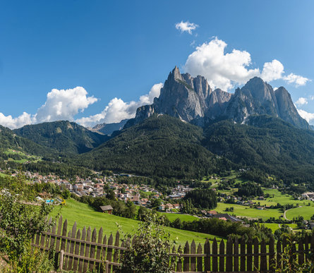 Seis am Schlern/Siusi allo Sciliar  with clear skies and the mountains in the background in summer