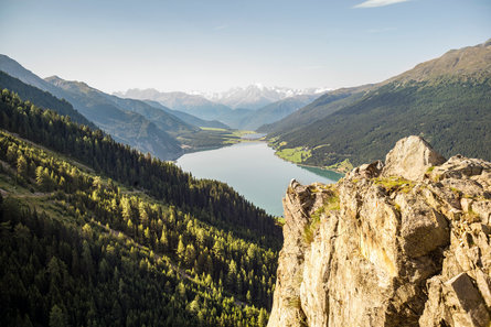 Panoramic view of the Reschensee lake in the Vinschgau Valley during a sunny summer day