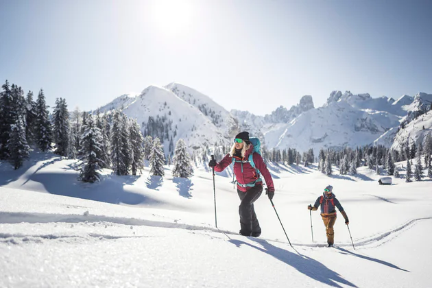 A woman and a man skitouring in the Dolomites