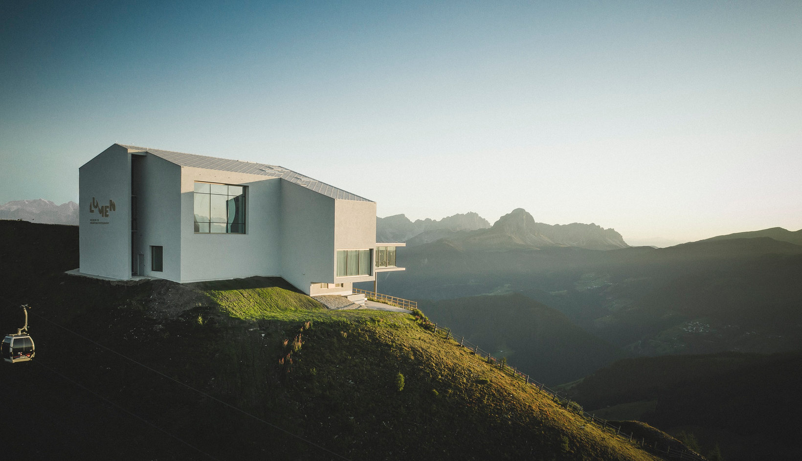 The particolar architecture of the LUMEN Museum with a panoramic view over the mountains in the background