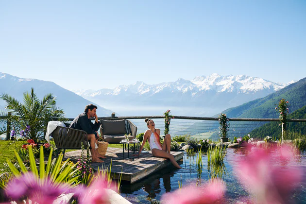 People relaxing on a terrace by the pool