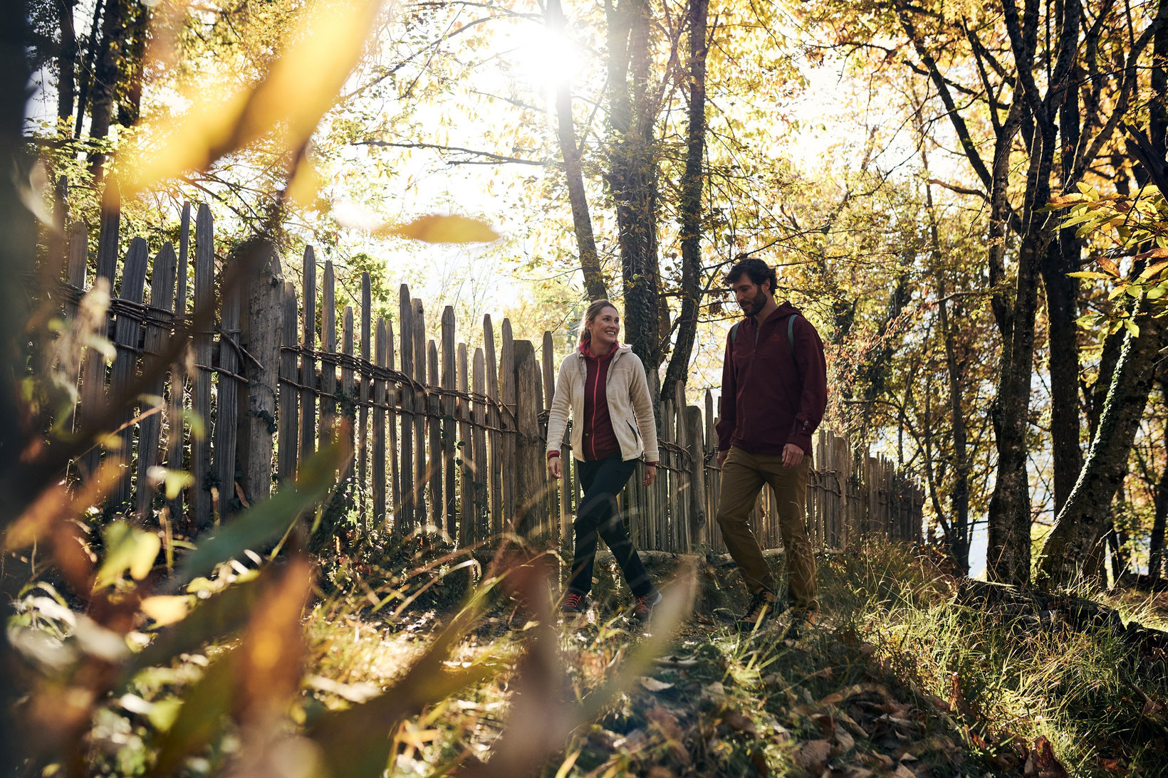 Two people walking across a meadow