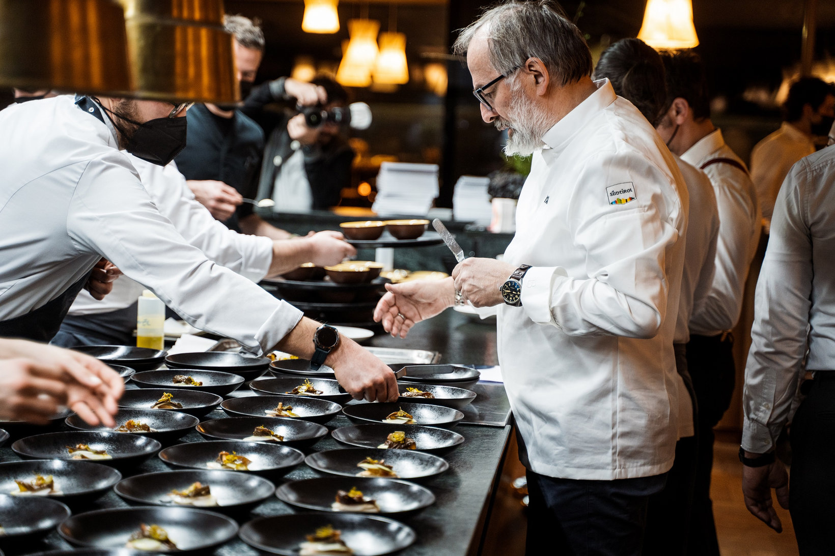 Celebrity chef Norbert Niederkofler inspects dishes before serving them in the AlpINN kitchen.